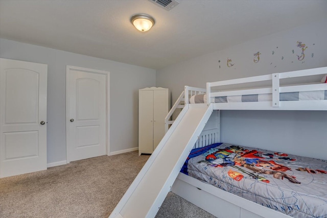 carpeted bedroom with visible vents and baseboards