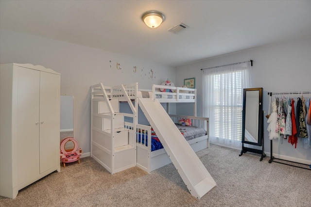 carpeted bedroom with visible vents and baseboards