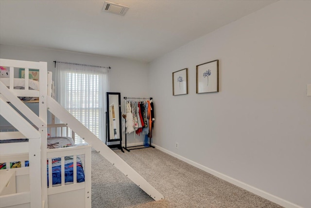 carpeted bedroom with baseboards and visible vents