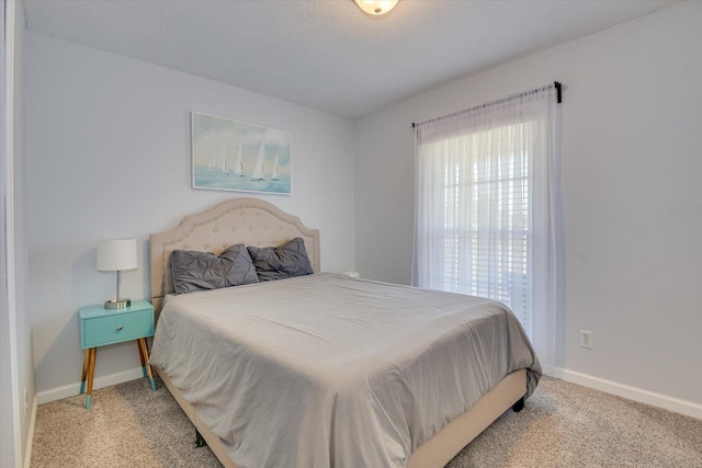 bedroom with carpet floors and baseboards