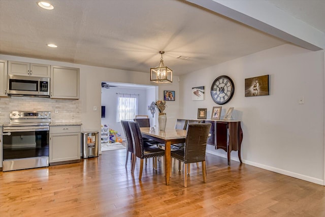 dining room featuring light wood-style floors, recessed lighting, baseboards, and ceiling fan with notable chandelier