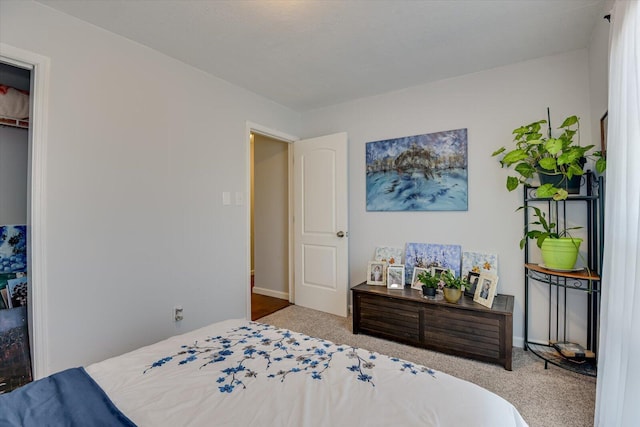 bedroom with carpet floors, a closet, and baseboards