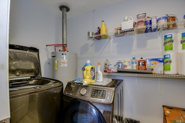 laundry room featuring water heater, laundry area, and washer and dryer