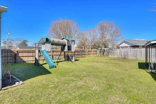 view of yard featuring a playground and a fenced backyard