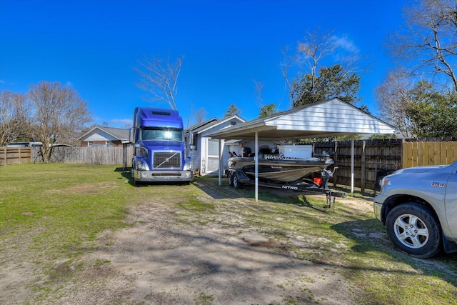 view of property exterior with a carport, a yard, and fence