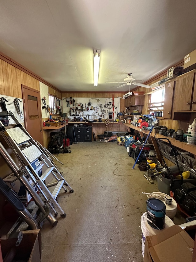 interior space featuring a ceiling fan and a workshop area