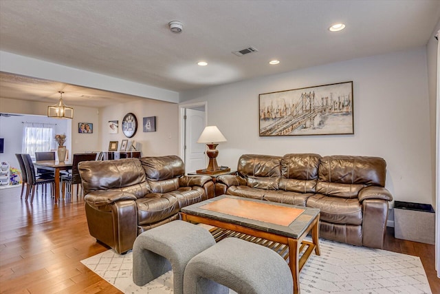 living area featuring light wood finished floors, visible vents, and recessed lighting