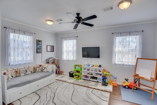 rec room featuring plenty of natural light, visible vents, and crown molding