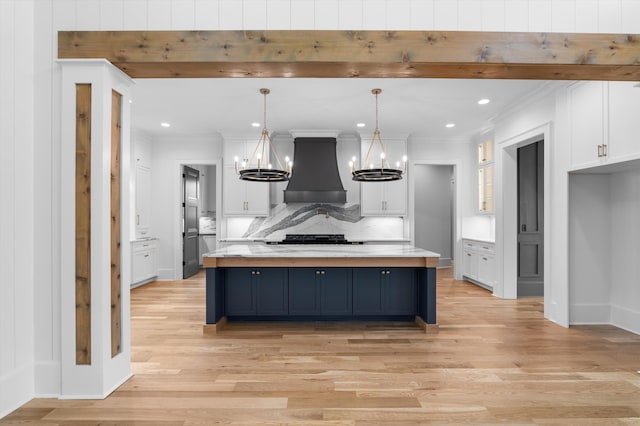 845 Audubon Way, Evans, GA 30809 - kitchen with custom range hood, white cabinetry, light countertops, backsplash, and crown molding