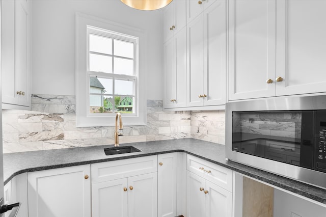 845 Audubon Way, Evans, GA 30809 - kitchen with stainless steel microwave, a sink, dark countertops, and white cabinetry