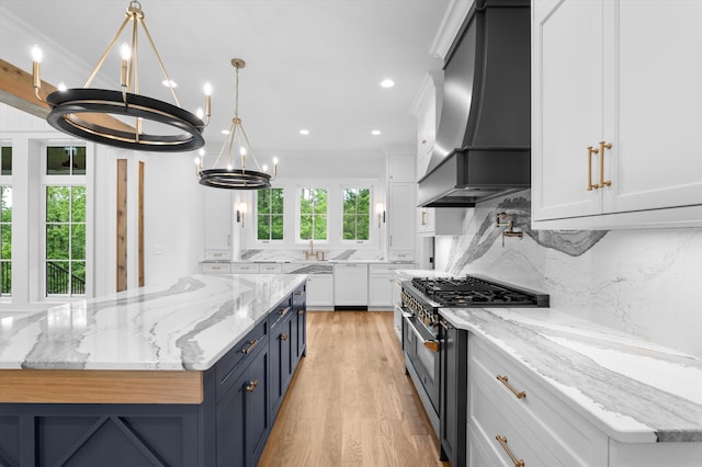 845 Audubon Way, Evans, GA 30809 - kitchen featuring wall chimney exhaust hood, range with two ovens, a chandelier, white cabinets, and blue cabinets