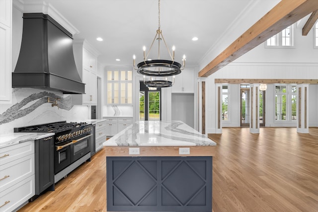 845 Audubon Way, Evans, GA 30809 - kitchen featuring premium range hood, double oven range, a chandelier, white cabinetry, and light wood-type flooring
