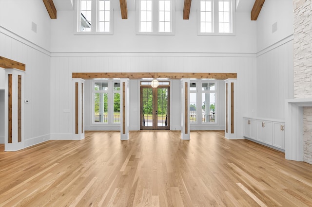 845 Audubon Way, Evans, GA 30809 - unfurnished living room featuring a towering ceiling, beam ceiling, plenty of natural light, french doors, and light wood finished floors