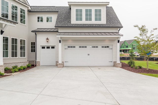845 Audubon Way, Evans, GA 30809 - view of front of house with a standing seam roof, concrete driveway, an attached garage, and a shingled roof
