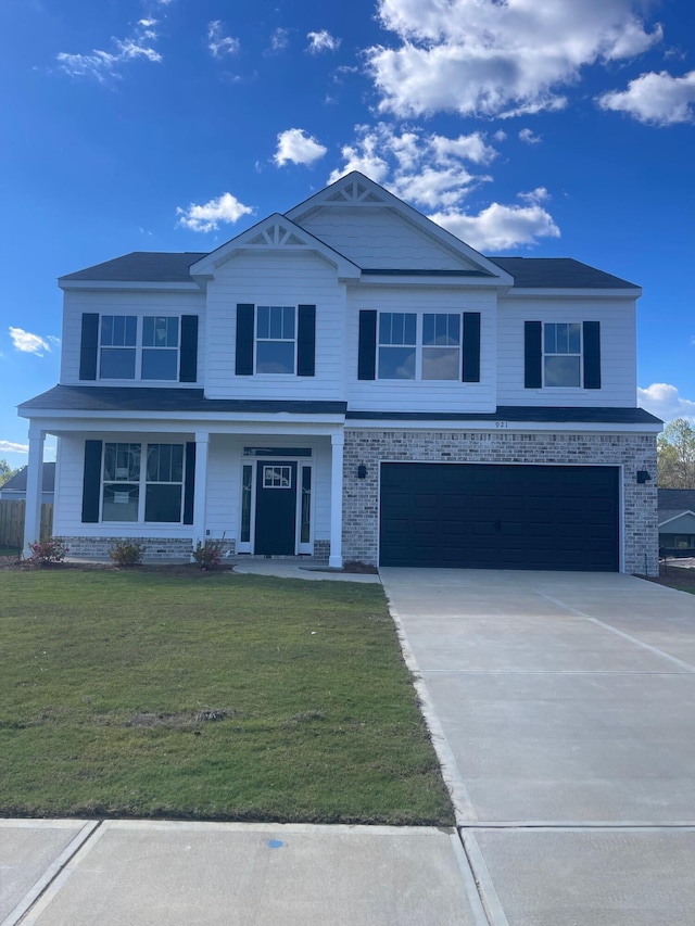 view of front of home with a front lawn and a garage