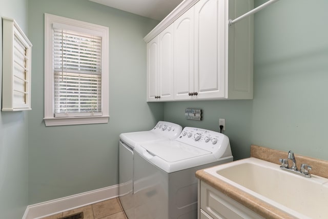 460 Armstrong Way, Evans, GA 30809 - washroom with washing machine and clothes dryer, cabinet space, healthy amount of natural light, and tile patterned floors