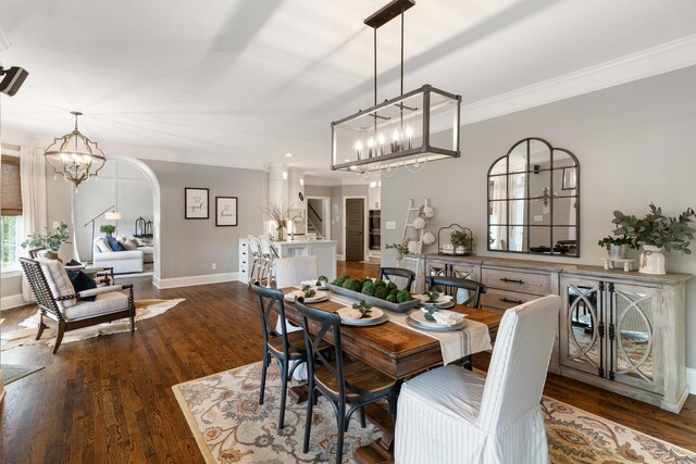 460 Armstrong Way, Evans, GA 30809 - dining area featuring a chandelier, dark wood-style floors, arched walkways, and ornamental molding