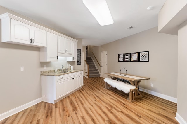 460 Armstrong Way, Evans, GA 30809 - kitchen featuring light wood-type flooring, white cabinets, and light stone countertops