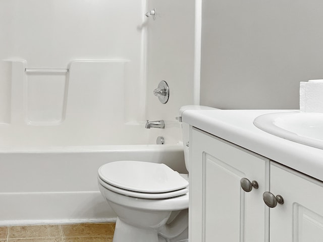 bathroom featuring tile patterned flooring, vanity, toilet, and bathing tub / shower combination
