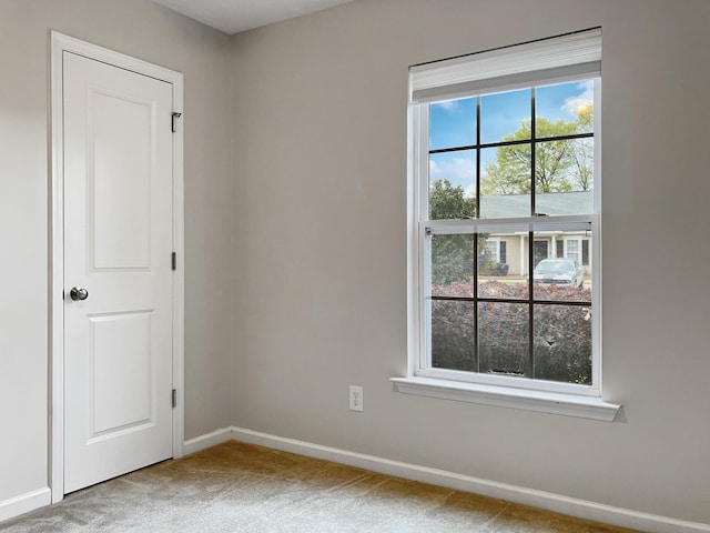unfurnished room featuring baseboards and carpet