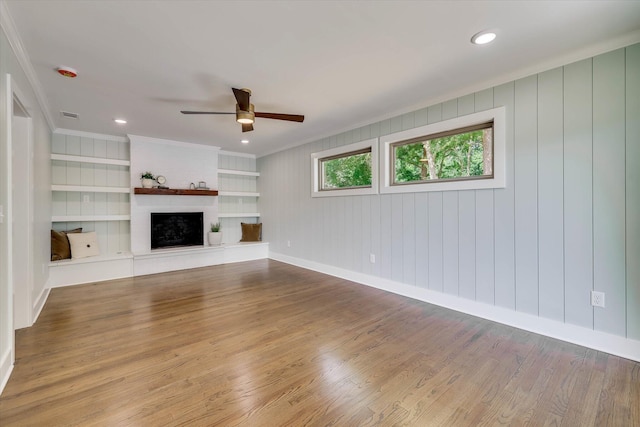 118 Lake Bluff Dr, Waynesboro, GA 30830 - unfurnished living room with wood finished floors, ceiling fan, ornamental molding, a fireplace, and built in features