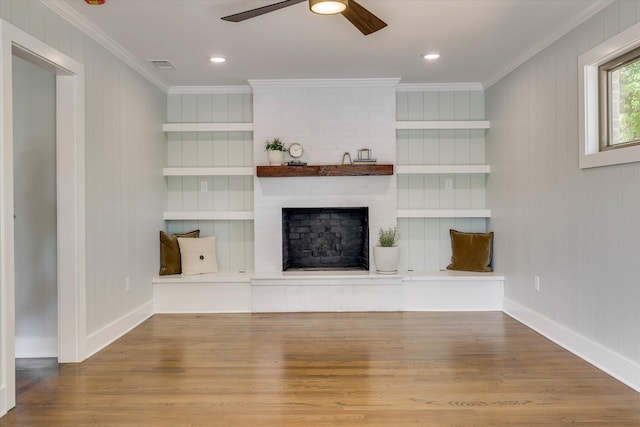 118 Lake Bluff Dr, Waynesboro, GA 30830 - unfurnished living room with ornamental molding, wood finished floors, a ceiling fan, a brick fireplace, and recessed lighting