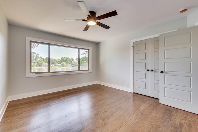 118 Lake Bluff Dr, Waynesboro, GA 30830 - unfurnished bedroom with wood finished floors, a closet, and ceiling fan