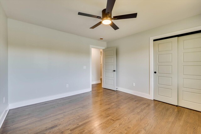 118 Lake Bluff Dr, Waynesboro, GA 30830 - unfurnished bedroom with wood finished floors, a closet, and ceiling fan