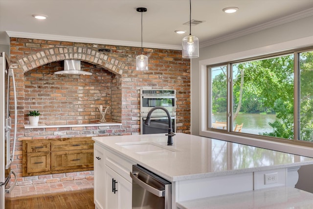 118 Lake Bluff Dr, Waynesboro, GA 30830 - kitchen featuring stainless steel appliances, crown molding, light stone countertops, white cabinetry, and hanging light fixtures