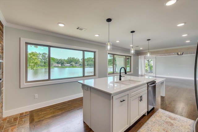 118 Lake Bluff Dr, Waynesboro, GA 30830 - kitchen featuring crown molding, white cabinets, light countertops, hanging light fixtures, and a center island with sink