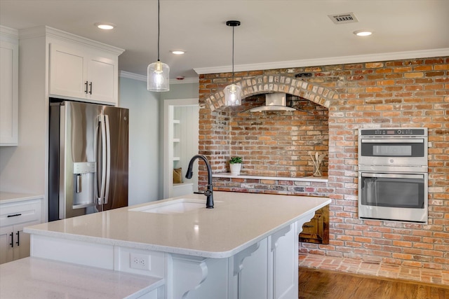 118 Lake Bluff Dr, Waynesboro, GA 30830 - kitchen featuring stainless steel appliances, white cabinets, decorative light fixtures, crown molding, and light stone countertops