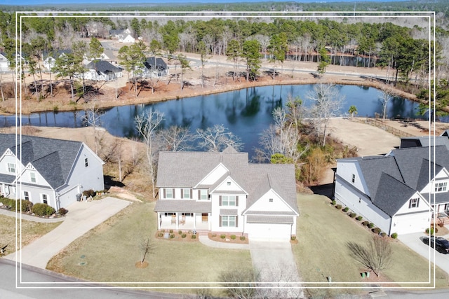 drone / aerial view with a water view and a residential view