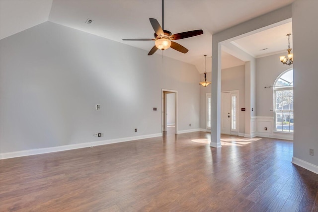 unfurnished living room with lofted ceiling, dark hardwood / wood-style floors, and ceiling fan with notable chandelier