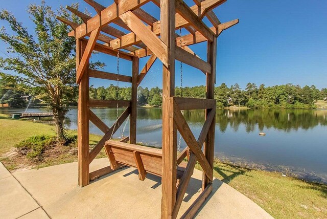 view of patio featuring a pergola and a water view