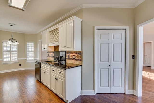 kitchen featuring sink, dishwasher, white cabinetry, backsplash, and a chandelier