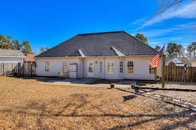 back of house featuring a patio and a yard