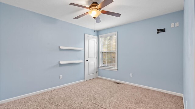 unfurnished room featuring ceiling fan and light carpet