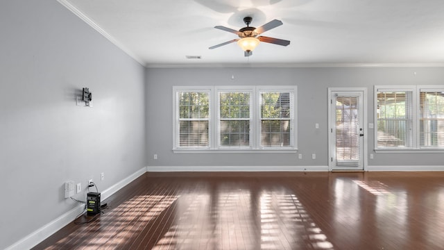 interior space featuring ceiling fan, ornamental molding, and dark wood-type flooring