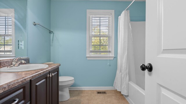 full bathroom featuring vanity, shower / tub combo, and toilet