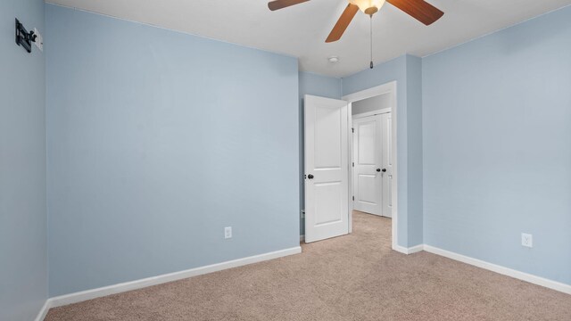 empty room with light carpet and ceiling fan