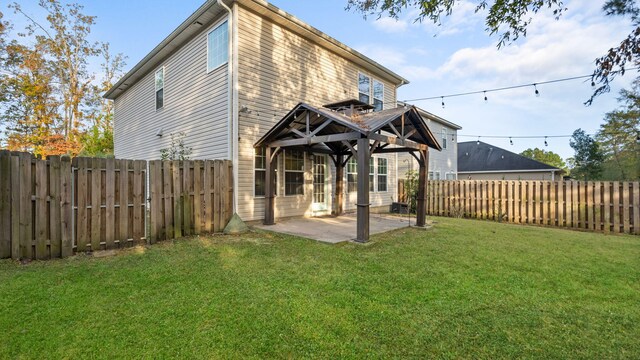 back of house featuring a patio and a lawn