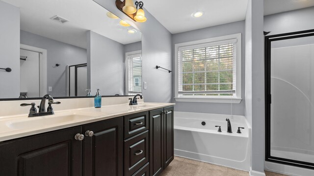 bathroom with vanity, tile patterned floors, and independent shower and bath