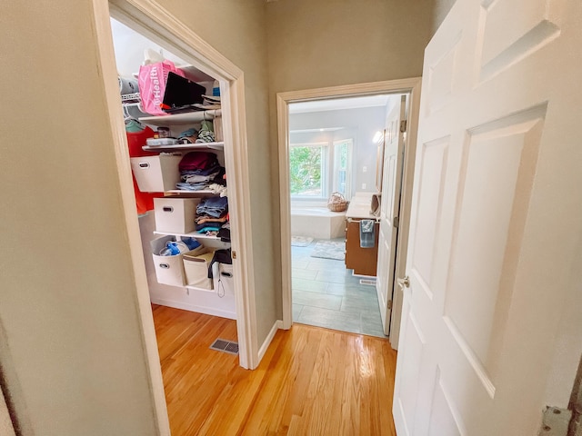hall with visible vents and light wood finished floors