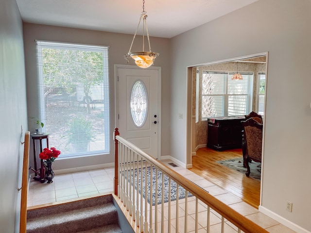 foyer entrance featuring wood finished floors and baseboards