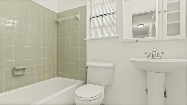 bathroom featuring toilet and bathtub / shower combination