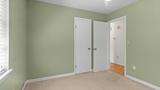 unfurnished bedroom featuring baseboards and carpet floors