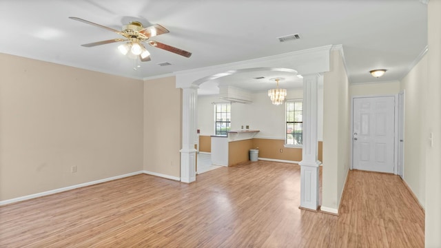 unfurnished living room with visible vents, decorative columns, light wood-style floors, and ceiling fan with notable chandelier