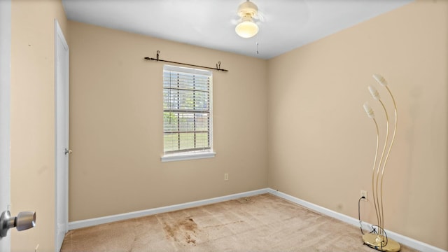 unfurnished room with baseboards, a ceiling fan, and carpet floors