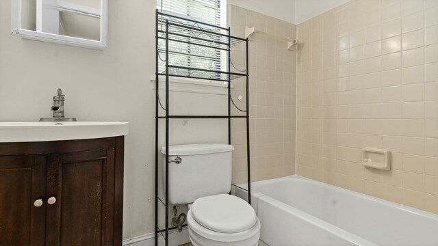 bathroom with toilet, shower / bath combination, and vanity