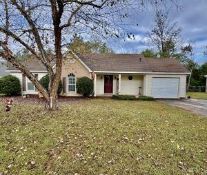 ranch-style house with a garage and a front lawn